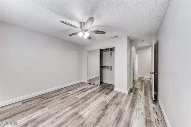 2200 S Fort Apache Rd Unit 2209, Las Vegas, NV 89117 - unfurnished bedroom featuring light wood-style flooring, a textured ceiling, a closet, and a ceiling fan