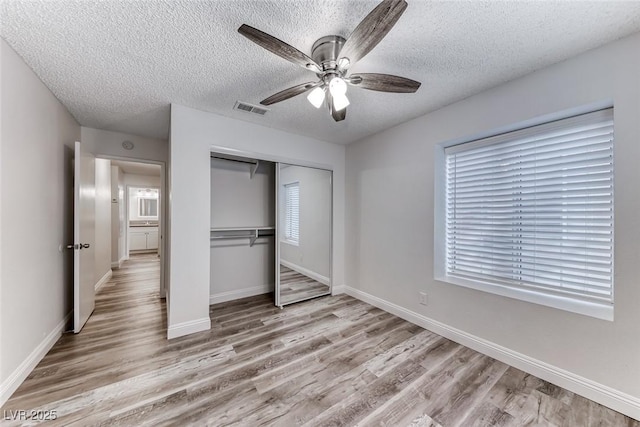 2200 S Fort Apache Rd Unit 2209, Las Vegas, NV 89117 - unfurnished bedroom featuring light wood-style floors, a closet, a textured ceiling, and a ceiling fan