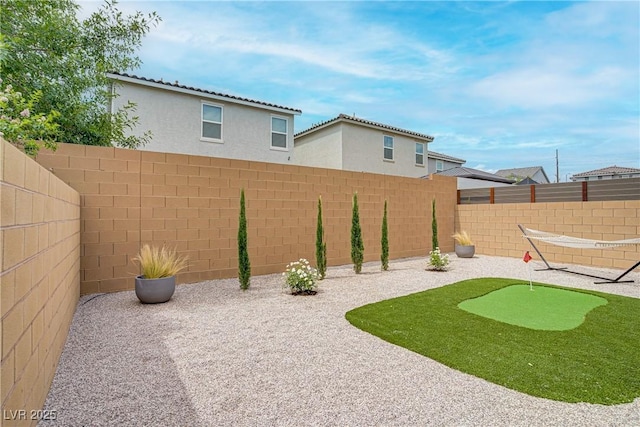 6591 Dove Point Pl, Las Vegas, NV 89130 - fenced backyard with a patio area and a putting area