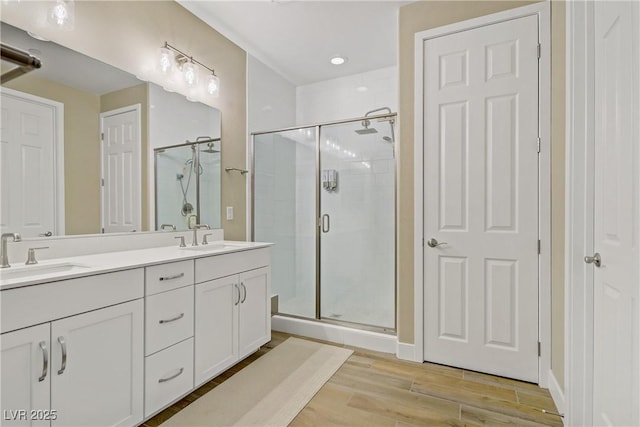 6591 Dove Point Pl, Las Vegas, NV 89130 - bathroom with a shower stall, double vanity, and wood finished floors