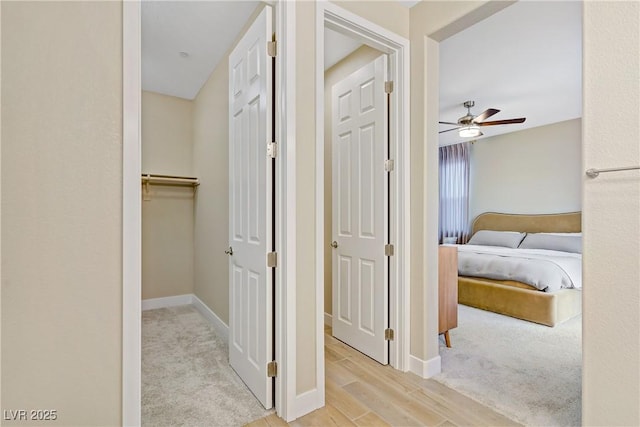 6591 Dove Point Pl, Las Vegas, NV 89130 - hallway featuring light wood-type flooring and light colored carpet