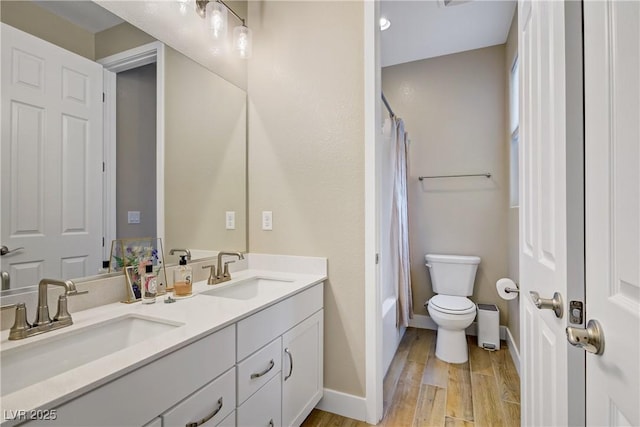6591 Dove Point Pl, Las Vegas, NV 89130 - bathroom with double vanity, wood finished floors, and shower / bath combo with shower curtain