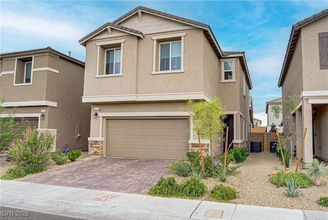 6591 Dove Point Pl, Las Vegas, NV 89130 - view of front of home featuring a tiled roof, decorative driveway, a garage, and stucco siding