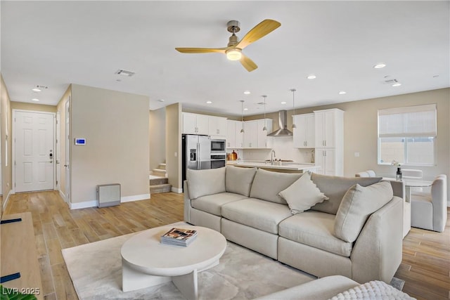 6591 Dove Point Pl, Las Vegas, NV 89130 - living area with a ceiling fan, light wood finished floors, stairway, and recessed lighting