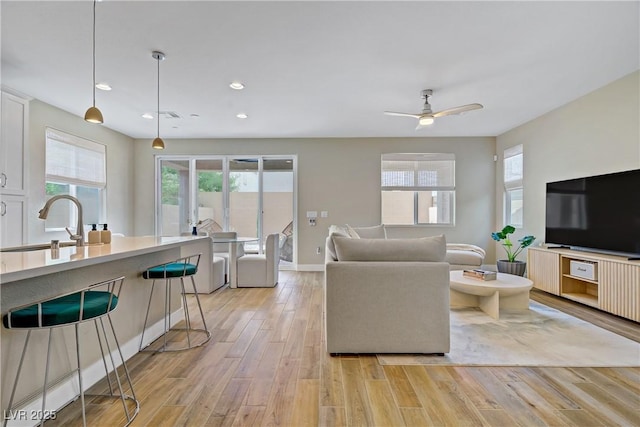 6591 Dove Point Pl, Las Vegas, NV 89130 - living area with light wood finished floors, healthy amount of natural light, recessed lighting, and a ceiling fan