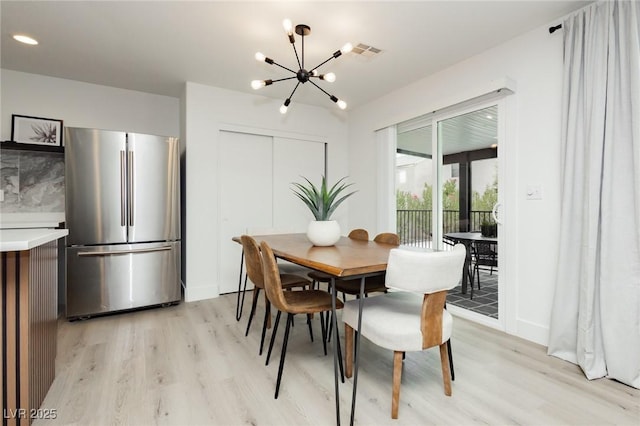 5505 Eagle Cove Ave, Las Vegas, NV 89130 - dining space with light wood-style flooring and a chandelier