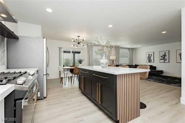 5505 Eagle Cove Ave, Las Vegas, NV 89130 - kitchen featuring stainless steel gas range, light wood-type flooring, light countertops, a chandelier, and recessed lighting