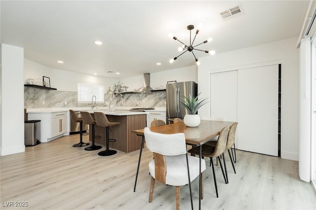 5505 Eagle Cove Ave, Las Vegas, NV 89130 - dining area with light wood-type flooring, a chandelier, and recessed lighting
