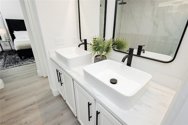 5505 Eagle Cove Ave, Las Vegas, NV 89130 - ensuite bathroom with wood finished floors, double vanity, and a marble finish shower