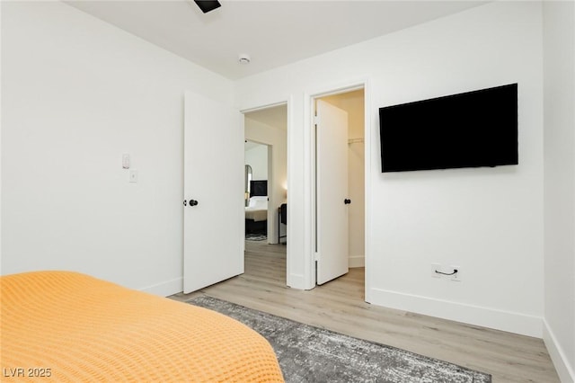 5505 Eagle Cove Ave, Las Vegas, NV 89130 - bedroom with light wood-style flooring, a walk in closet, and a closet