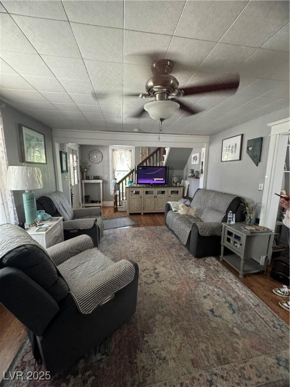 191 S Booker, Tonopah, NV 89049 - living room with wood finished floors, a ceiling fan, and stairway