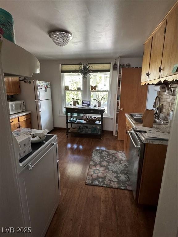 191 S Booker, Tonopah, NV 89049 - kitchen featuring white appliances, dark wood finished floors, and brown cabinetry