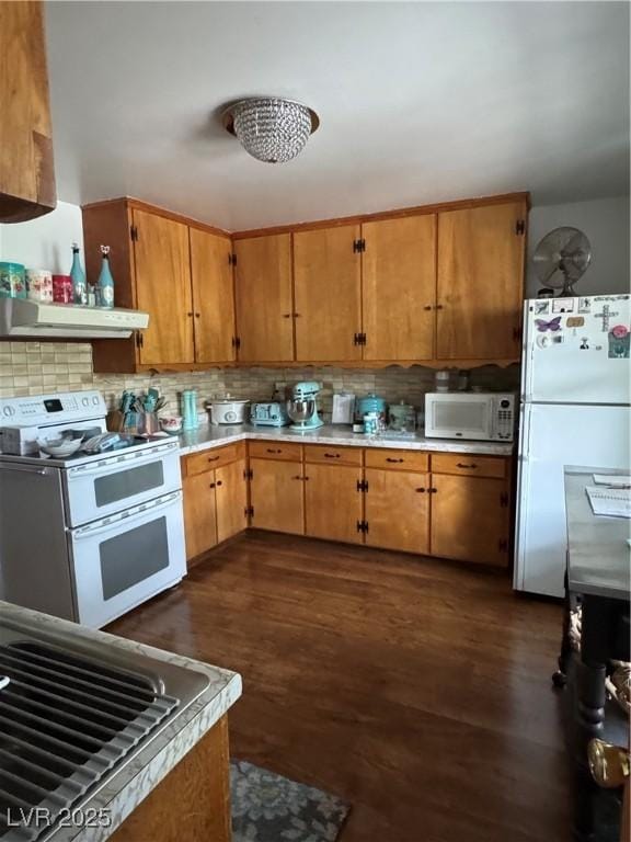 191 S Booker, Tonopah, NV 89049 - kitchen with white appliances, range hood, backsplash, light countertops, and dark wood finished floors