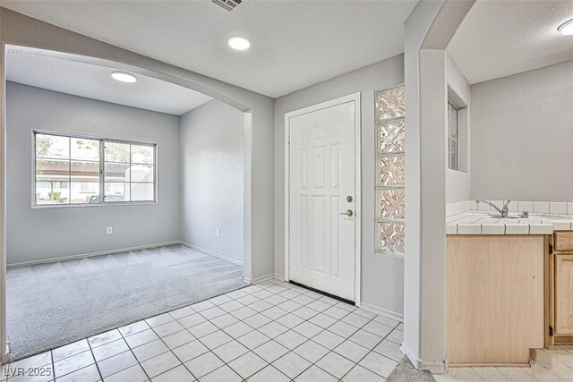 7400 W Flamingo Rd Unit 1051, Las Vegas, NV 89147 - entrance foyer with light carpet, arched walkways, recessed lighting, and light tile patterned floors