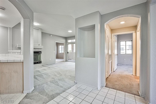 7400 W Flamingo Rd Unit 1051, Las Vegas, NV 89147 - corridor featuring light carpet, arched walkways, light tile patterned floors, and recessed lighting