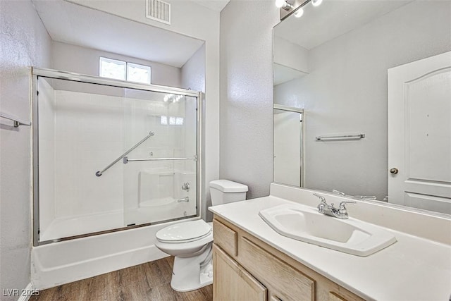 7400 W Flamingo Rd Unit 1051, Las Vegas, NV 89147 - full bathroom featuring wood finished floors, vanity, enclosed tub / shower combo, and a textured wall