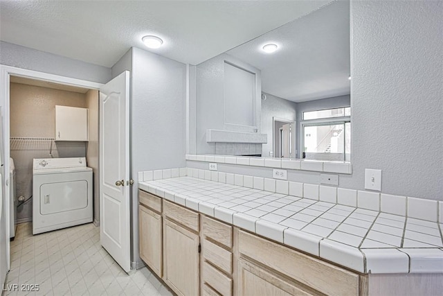 7400 W Flamingo Rd Unit 1051, Las Vegas, NV 89147 - bathroom with washer / dryer, a textured wall, and tile patterned floors
