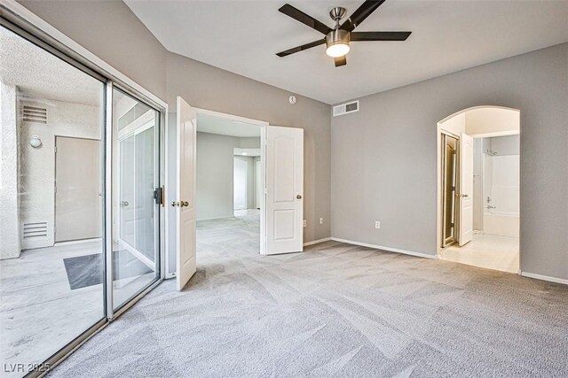 7400 W Flamingo Rd Unit 1051, Las Vegas, NV 89147 - unfurnished bedroom with arched walkways, carpet flooring, a ceiling fan, access to exterior, and connected bathroom