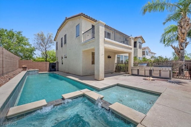 9413 Arcadia Woods Ct, Las Vegas, NV 89149 - view of pool featuring an outdoor kitchen, a fenced backyard, a patio, and a pool with connected hot tub