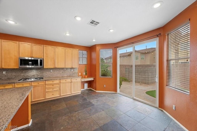 9413 Arcadia Woods Ct, Las Vegas, NV 89149 - kitchen with stainless steel appliances, tasteful backsplash, light brown cabinetry, recessed lighting, and light stone countertops