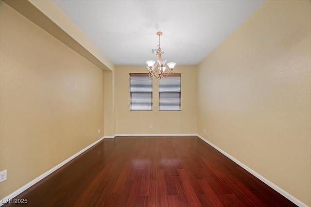 9413 Arcadia Woods Ct, Las Vegas, NV 89149 - empty room featuring dark wood-style floors and a chandelier