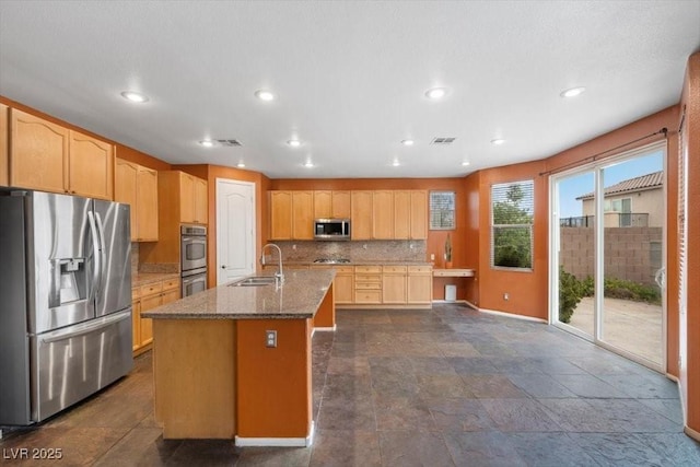 9413 Arcadia Woods Ct, Las Vegas, NV 89149 - kitchen with stainless steel appliances, stone countertops, tasteful backsplash, a center island with sink, and recessed lighting