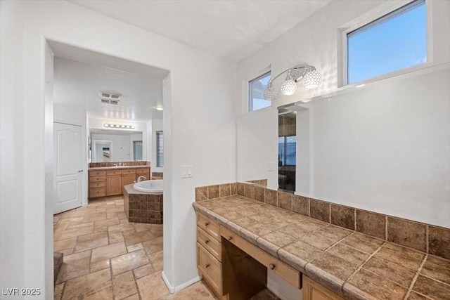 9413 Arcadia Woods Ct, Las Vegas, NV 89149 - full bath with stone tile flooring, a bath, and vanity