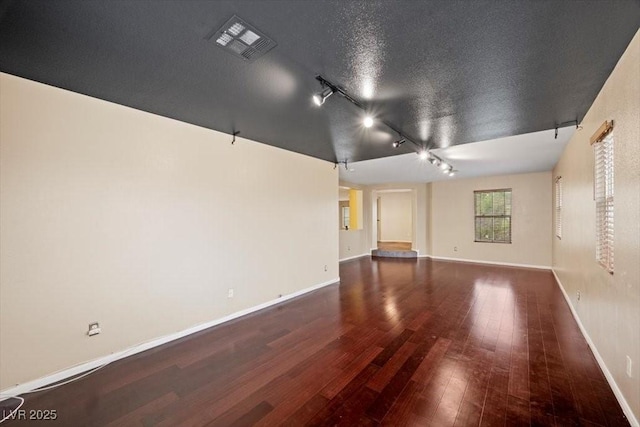 9413 Arcadia Woods Ct, Las Vegas, NV 89149 - empty room featuring track lighting and hardwood / wood-style flooring