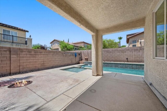 9413 Arcadia Woods Ct, Las Vegas, NV 89149 - view of swimming pool with an outdoor fire pit, a patio, a fenced backyard, and a pool with connected hot tub