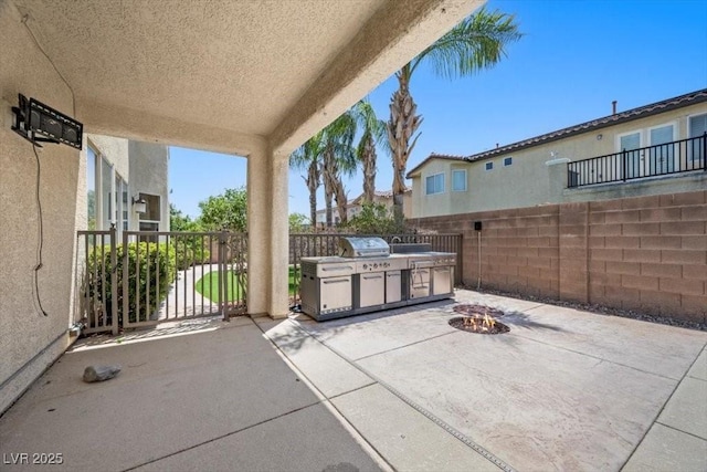 9413 Arcadia Woods Ct, Las Vegas, NV 89149 - view of patio / terrace with an outdoor fire pit and exterior kitchen