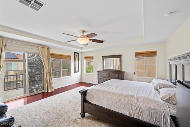 9413 Arcadia Woods Ct, Las Vegas, NV 89149 - bedroom with a tray ceiling, access to exterior, wood finished floors, and a ceiling fan
