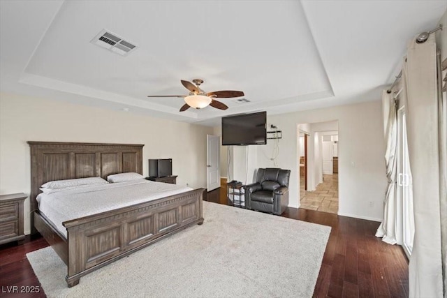 9413 Arcadia Woods Ct, Las Vegas, NV 89149 - bedroom featuring a raised ceiling, dark wood finished floors, and a ceiling fan