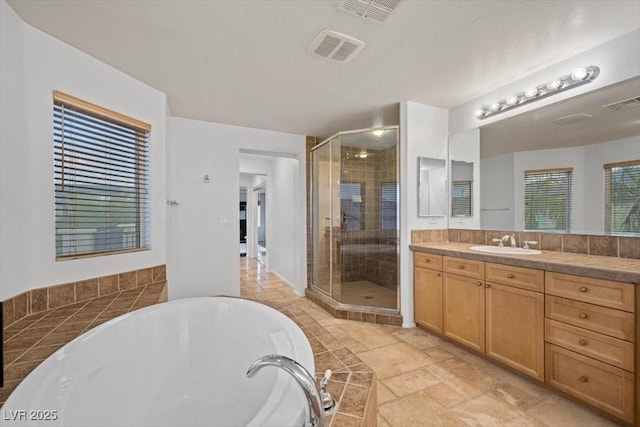9413 Arcadia Woods Ct, Las Vegas, NV 89149 - full bathroom with a bathtub, vanity, a shower stall, and stone tile floors