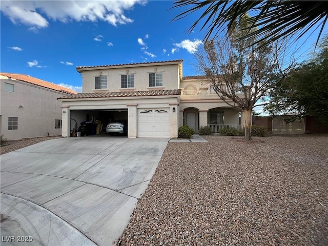 mediterranean / spanish-style home with stucco siding, a porch, concrete driveway, a garage, and a tiled roof