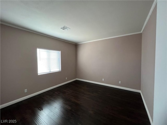 empty room featuring crown molding and dark wood-style floors