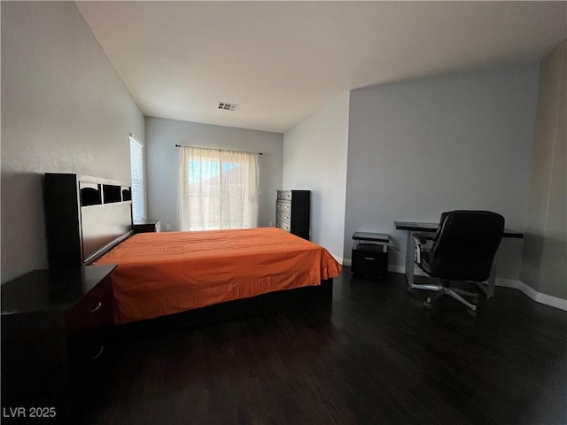 bedroom featuring wood finished floors and baseboards