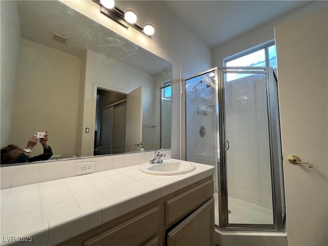 bathroom featuring vanity and a stall shower