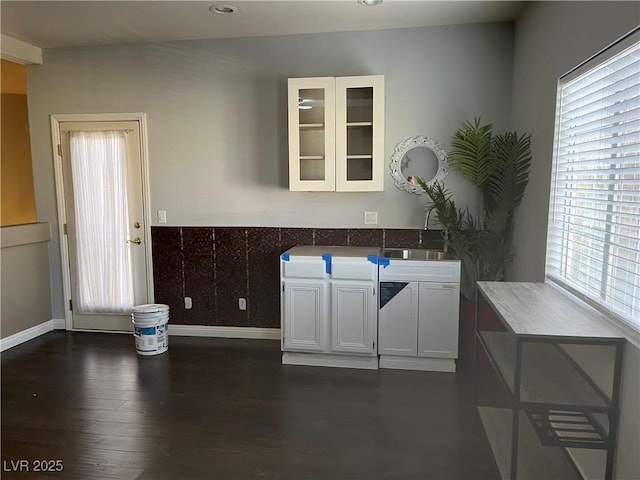kitchen featuring white cabinets, glass insert cabinets, plenty of natural light, dark wood-type flooring, and recessed lighting