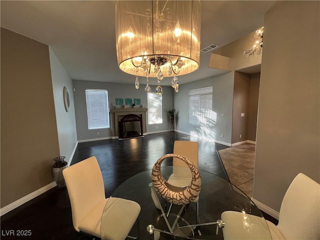 living area featuring a chandelier, wood finished floors, and a premium fireplace