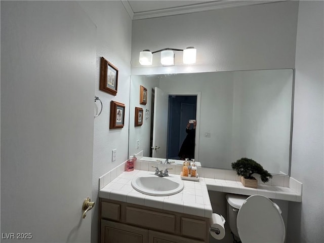 half bathroom featuring vanity and ornamental molding