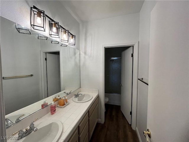 bathroom with double vanity and wood finished floors
