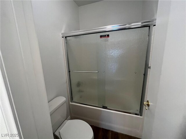 bathroom featuring combined bath / shower with glass door and wood finished floors