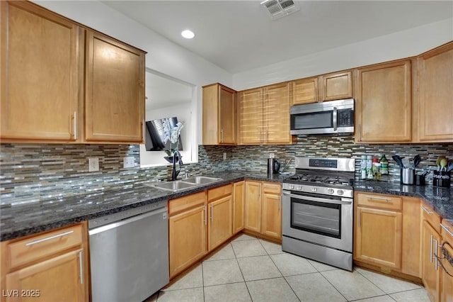 6430 Jackrabbit Run Ave, Las Vegas, NV 89122 - kitchen featuring stainless steel appliances, light tile patterned floors, tasteful backsplash, dark stone counters, and recessed lighting