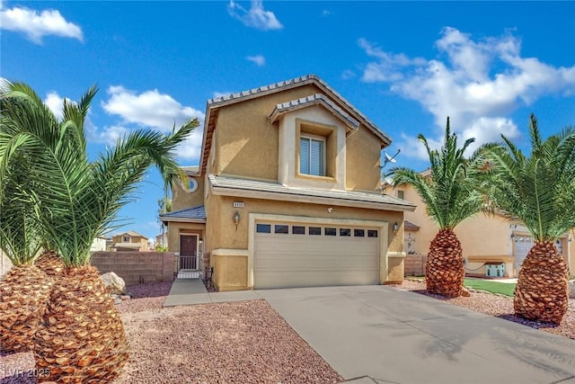 6430 Jackrabbit Run Ave, Las Vegas, NV 89122 - view of front of property featuring an attached garage, stucco siding, and driveway
