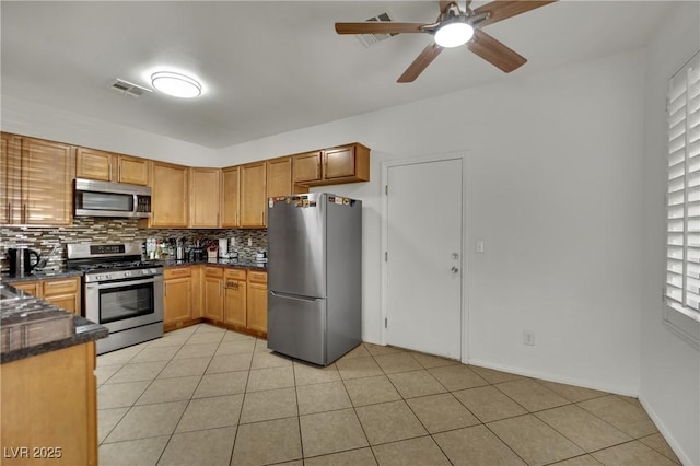 6430 Jackrabbit Run Ave, Las Vegas, NV 89122 - kitchen featuring appliances with stainless steel finishes, decorative backsplash, a ceiling fan, and light tile patterned floors
