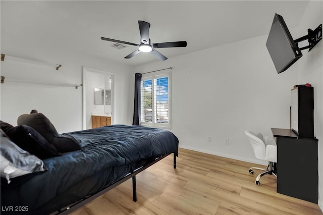 6430 Jackrabbit Run Ave, Las Vegas, NV 89122 - bedroom with light wood-style floors, a ceiling fan, and connected bathroom