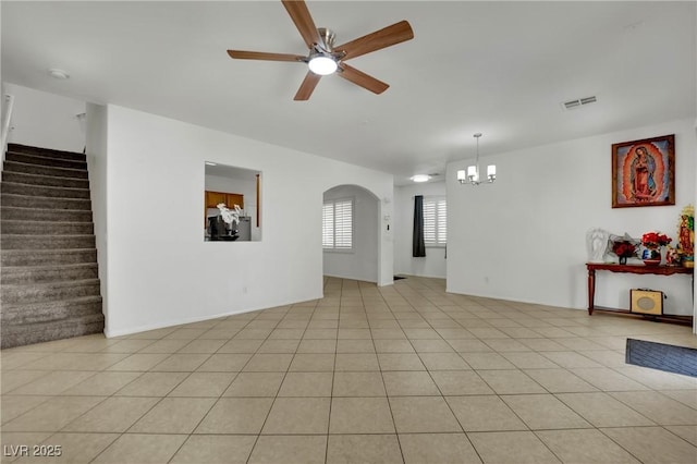 6430 Jackrabbit Run Ave, Las Vegas, NV 89122 - empty room with ceiling fan, a chandelier, stairway, arched walkways, and light tile patterned flooring