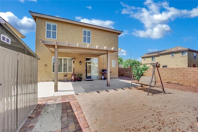 6430 Jackrabbit Run Ave, Las Vegas, NV 89122 - back of property featuring stucco siding, a patio area, and a fenced backyard