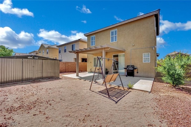 6430 Jackrabbit Run Ave, Las Vegas, NV 89122 - back of property featuring stucco siding, a pergola, a patio, and a fenced backyard