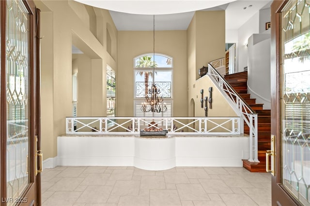 7520 Captains Harbor Dr, Las Vegas, NV 89117 - foyer entrance featuring healthy amount of natural light, stairs, a high ceiling, and stone tile flooring